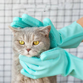 Green silicone dog grooming gloves with soft rubber bristles for pet hair removal and massage