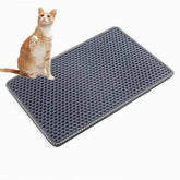 Grey double-layer cat litter mat with rice-shaped holes for trapping litter and protecting floors